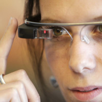 A woman wears Google glasses after a media presentation of a Google apartment in Prague